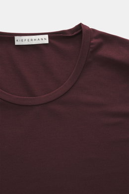 Close-up top-down view of Kiefermann Crew neck T-shirt 'Hero' burgundy, showing crew neck and label, featuring a blend of cotton and modal, elasticated fabric, soft touch, slim fit, and crew neck design.