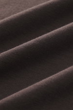 Close-up, angled view of dark brown fabric texture of Kiefermann Crew neck T-shirt 'Hero', showing blend of cotton and modal, elasticated fabric, soft touch, slim fit, crew neck.