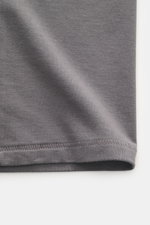 Close-up view of the hem and fabric texture of the Kiefermann Crew neck T-shirt 'Hero' dark grey, showcasing a blend of cotton and modal, elasticated fabric, soft touch, slim fit, and crew neck.