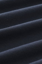 Close-up image from a top-down perspective showing the fabric texture of the Kiefermann Crew neck long sleeve 'Alberts' navy, jersey in modal and cotton, elasticated fabric, soft touch, slim fit, crew neck.