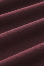 Close-up front view of burgundy fabric texture showing the soft, elasticated jersey in modal and cotton of the Kiefermann Crew neck long sleeve 'Alberts' burgundy, slim fit with a soft touch and crew neck.