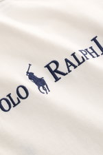 Close-up front view of Polo Ralph Lauren Crew neck T-shirt white showing navy blue signature logo stitching on pure cotton fabric.

<p>A timeless classic for hot days: This T-shirt by POLO RALPH LAUREN features a signature logo and a casual boxy fit that 