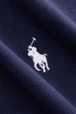 Close-up front view of the Polo Ralph Lauren Crew neck T-shirt navy showing white embroidered signature logo on textured cotton fabric.

<p>A timeless classic for hot days: This T-shirt by POLO RALPH LAUREN features a signature logo and a casual boxy fit 