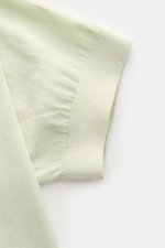 Close-up view of the sleeve cuff of the 04651/ A trip in a bag Kurzarmpullover 'Pima Cotton' pastellgrün, made from fine Pima cotton with a soft feel, very fine knit, slim fit, round neckline, and flexible ribbed cuffs, shown from a top angle.