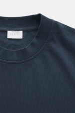 Close-up top-down view of the 04651/ A trip in a bag Crew neck T-Shirt navy showing crew neckline, heavy cotton jersey, slightly textured feel, regular fit, small woven label. Durable basic for urban everyday life.