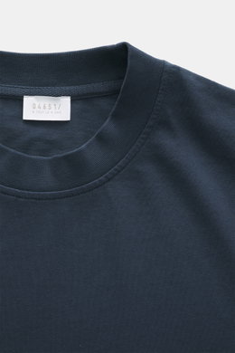 Close-up top-down view of the 04651/ A trip in a bag Crew neck T-Shirt navy showing crew neckline, heavy cotton jersey, slightly textured feel, regular fit, small woven label. Durable basic for urban everyday life.