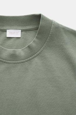 Close-up front view of 04651/ A trip in a bag Crew neck T-Shirt grey green showing crew neckline, small woven label, pure cotton, heavy quality, slightly textured feel, and regular fit. Durable basic for urban everyday life.