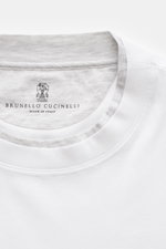 Close-up top-down view of Brunello Cucinelli Crew neck T-shirt white/light grey melange showing neckline with contrasting double hem and brand label.

<p>BRUNELLO CUCINELLI delivers an essential basic for your casual wardrobe with this relaxed T-shirt in 