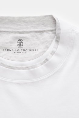 Close-up top-down view of Brunello Cucinelli Crew neck T-shirt white/light grey melange showing neckline with contrasting double hem and brand label.

<p>BRUNELLO CUCINELLI delivers an essential basic for your casual wardrobe with this relaxed T-shirt in 