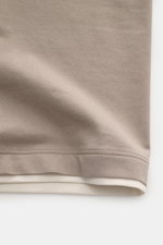 Close-up from top front showing the taupe and cream hem of the Brunello Cucinelli Crew neck T-shirt taupe/cream in soft cotton fabric with slim fit.

<p>BRUNELLO CUCINELLI delivers an essential basic for your casual wardrobe with this relaxed T-shirt in c