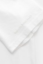 Moose Knuckles Crew neck T-shirt 'Crescent Tee' white shown from a close-up side angle, featuring pure Pima cotton, soft feel, slim fit, crew neck, signature patch with metal logo on chest, rubberised label print on sleeve, and small woven label in side s