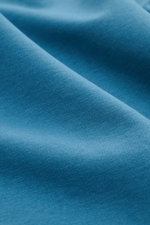 Close-up view of teal fabric texture showing fine knit details of the 04651/ A trip in a bag Crew neck long sleeve 'If Tee' teal.

Description: 
<p>The uncomplicated long sleeve 'IF Tee' by 04651/ A TRIP IN A BAG is a core basic for the new season that gi
