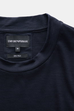 Close-up front view of the Emporio Armani Longsleeve navy collar and label showing pure wool fabric, soft feel, regular fit, and crew neckline.