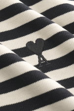 Close-up front view of Ami Paris Longsleeve black/cream striped showing textured cotton jersey, embroidered heart logo, and knit details.

Description:  
<p>With this longsleeve from AMI PARIS, you can perfectly combine urban looks – the Breton look and t