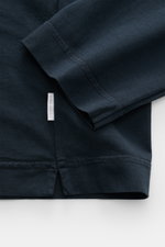 Close-up from above of the navy 04651/ A trip in a bag Longsleeve 'Jersey Tee' showing soft pure cotton jersey fabric, round neckline, short hem slits, and regular fit. Versatile basic, lightweight and comfortable layering piece.