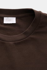 Nahaufnahme des Rundhalsausschnitts vom braunen 04651/ A trip in a bag Longsleeve 'IF Tee', weicher Jersey, Regular Fit, kurze Saumschlitze.