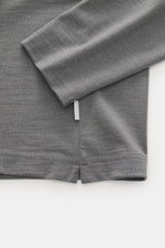 Close-up top view of the sleeve and hem of the 04651/ A trip in a bag Longsleeve 'WJ Tee' grey melange, showing soft fabric and stitching. Versatile basic: The soft long sleeve 'WJ Tee' from 04651/ A TRIP IN A BAG combines the highest material quality wit