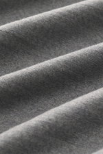 Close-up fabric texture of 04651/ A trip in a bag Longsleeve 'WJ Tee' grey melange, photographed from a top angle, showing soft wool and microfiber blend.