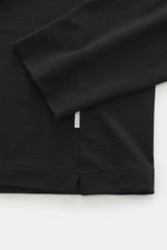 Close-up image showing the sleeve and hem details of the 04651/ A trip in a bag Longsleeve 'WJ Tee' black, photographed from above. Versatile basic: The soft longsleeve combines a mix of wool and high-quality microfiber, very soft touch, regular fit, roun