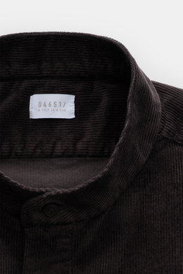 Close-up top-front view of the dark brown 04651/ A trip in a bag Popover corduroy shirt grandad collar, showcasing soft corduroy texture, regular fit, classic barrel cuffs, and straight hem. Timeless all-rounder: this popover corduroy shirt by 04651/ A TR