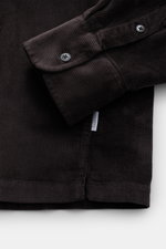 Close-up front view of the dark brown 04651/ A trip in a bag Popover corduroy shirt grandad collar showing sleeve with classic barrel cuff, soft cotton-modal blend, regular fit, and straight hem.