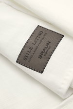 Close-up front angle of the Stile Latino Overshirt 'Gbu Teseo' cream showing the black stitched label on soft pure cotton fabric. <p>Luxurious layers: This sophisticated overshirt by STILE LATINO combines exquisite quality with timeless elegance – a styli