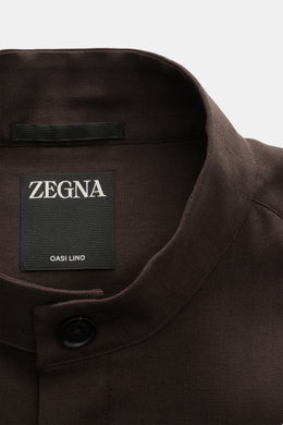 Close-up top-down view of the Zegna Linen overshirt dark brown showing the grandad collar, button, and interior label with "ZEGNA" and "OASI LINO." 

<p>Minimalism from ZEGNA: This casual overshirt in pure linen features a lightweight, clean design – perf