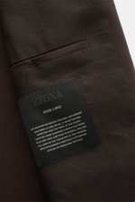 Close-up top-down view of the Zegna Linen overshirt dark brown showing fabric texture and inside pocket label with brand text.

<p>Minimalism from ZEGNA: This casual overshirt in pure linen features a lightweight, clean design – perfect for elegant layeri