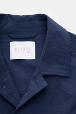 Nahaufnahme des navyfarbenen 04651/ A trip in a bag Overshirt 'Technical Seersucker' mit Umlegekragen und strukturierter Microfaser, Slim Fit, aus frontaler Perspektive.