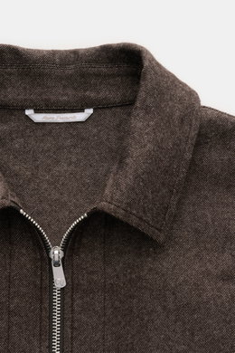 Close-up front top view of Marco Pescarolo Overshirt 'Urus' brown melange showing turn-down collar, two-way zipper, and fine woven texture, made of cashmere-cotton blend.  

Description: <p>MARCO PESCAROLO impresses with the traditionally Italian-made ove