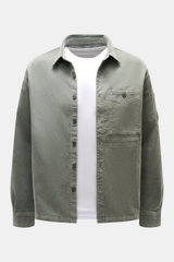 Front view of C.P. Company Cord Overshirt Grey Green in slim fit, soft elastic cotton corduroy with chest and upper arm pockets.

Description: <p>Casualwear with character: The Cord Overshirt from C.P. COMPANY impresses with soft cotton quality, distincti