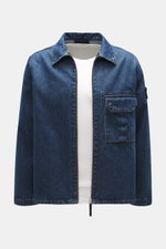 Stone Island Blue denim jacket front view, slim fit with turn-down collar, two-way zipper, patch chest pocket, compass badge on upper arm, denim made of pure cotton with typical material texture.
