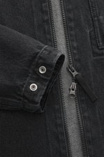 Stone Island Denim Overshirt dark grey close-up from front showing slim fit, denim pure cotton, typical material structure, robust two-way zipper, turn-down collar, patch chest pocket, compass badge on upper arm, and buttoned sleeve cuffs.