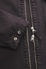 Close-up front view of Stone Island Jeansjacke 'Light Bull Denim-TC' dunkelbraun showing garment dyed pure cotton denim with a slim fit, concealed zipper, buttoned cuff, and textured fabric. Robust aesthetic from the 'Denim' capsule with lightweight feel,
