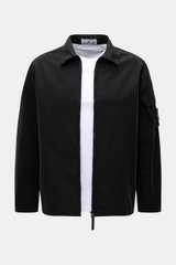 Stone Island Overshirt 'Canvas' black shown from the front, featuring a turn-down collar, robust two-way zipper, patch pocket with flap on sleeve, adjustable snap button cuffs, and the typical compass badge; made of pure organic cotton canvas, garment dye