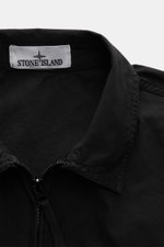 Close-up front view of Stone Island Overshirt 'Canvas' black, showing turn-down collar, durable zipper, and brand label inside collar, made from pure organic cotton canvas with robust utility design. Robust utility look with iconic character: This overshi
