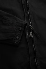 Close-up front view of Stone Island Overshirt 'Canvas' black showing robust two-way zipper, adjustable cuff with snap buttons, made of pure organic cotton canvas.