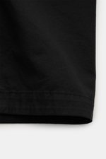 Close-up front view of Stone Island Overshirt 'Canvas' black showing durable, garment-dyed pure organic cotton canvas fabric with neat stitching, highlighting robust utility design and unlined regular fit.