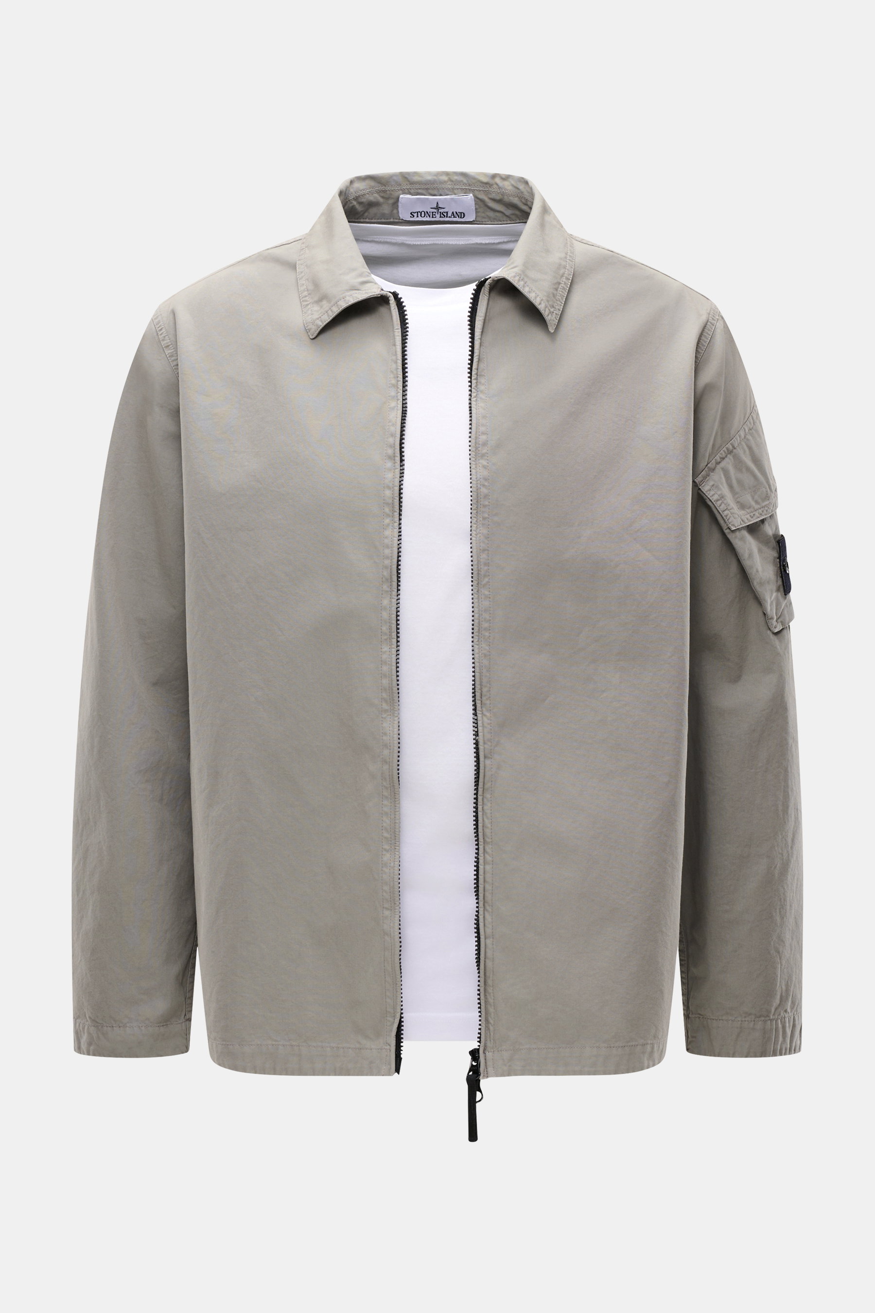 Front view of Stone Island Overshirt 'Canvas' grey, showcasing a regular fit canvas overshirt made from pure organic cotton with a turn-down collar, robust two-way zipper, patch pocket with flap on the sleeve with the typical compass badge, adjustable sna