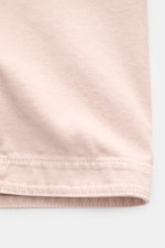 Close-up front view of Stone Island Overshirt Dusky Pink made of pure cotton with a slightly textured feel, showing five-button placket, turn-down collar, patch chest pocket, compass badge on upper arm, and button cuffs.

<p>Timeless layering essential: T