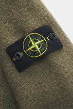 Close-up of the Stone Island Overshirt olive fabric showing the compass badge on the upper arm, photographed from a side angle.

Description:  
<p>Timeless layering essential: The boucle overshirt from STONE ISLAND complements autumn and winter looks with