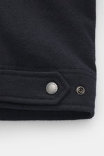 Close-up front-side view of the Woolrich Down jacket navy melange showing wool and microfiber fabric, snap button placket, adjustable collar with button tab, quilted smooth lining, slanted welt pockets, cuff sleeves with cuffs, adjustable waist width, lig