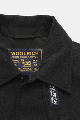 Close-up front view of the Woolrich Down jacket black melange collar showing wool and microfiber fabric, light down filling, snap button placket, adjustable collar with button tab, slanted welt pockets, cuff sleeves with cuffs, adjustable waist width, qui