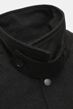 Close-up front view of the Woolrich Down jacket black melange showing wool and microfiber fabric, light down filling, slim fit, snap button placket, adjustable collar with button tab, slanted welt pockets, cuff sleeves with cuffs, adjustable waist width, 