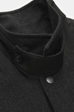 Close-up front collar view of Woolrich Down jacket 'Alaskan' black melange in wool and microfiber, light down filling, slim fit, snap button placket, adjustable collar with button tab, patch chest pockets, slanted welt pockets, sleeve cuffs with cuff, qui