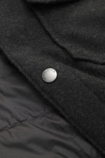 Close-up from above of the Woolrich Down jacket 'Alaskan' black melange showing wool and microfiber fabric, light down filling, snap button placket, and quilted smooth lining fabric.