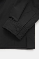 Nahaufnahme des Ärmelabschlusses mit Knopf und tonalem Futterstoff, seitliche Perspektive des Ami Paris Overshirt schwarz aus hochwertiger Microfaser.