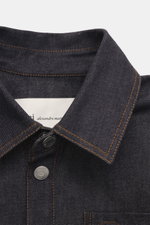 Close-up front view of Ami Paris Denim overshirt navy showing pure cotton, textured feel, heavy quality, oversized fit, snap button placket, turn-down collar, patch chest pocket with logo stitching, cuffed sleeve ends, unlined.