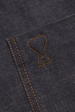 Close-up front view of Ami Paris Denim overshirt navy showing patch chest pocket with logo stitching, pure cotton, textured feel, heavy quality, oversized fit, snap button placket, turn-down collar, cuffed sleeve ends, and unlined fabric.