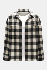 Ami Paris Overshirt black/cream checkered shown from the front, oversized fit, pure new wool lumberjack style with snap buttons, adjustable collar, patch chest pockets with flaps, classic sport cuffs, rounded hemline extended at the back, worn over a whit